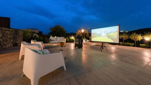 a man standing on a patio with a large screen at Le Pavilion Pool Villa in Pohang