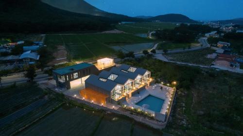 an aerial view of a large house with a swimming pool at Le Pavilion Pool Villa in Pohang