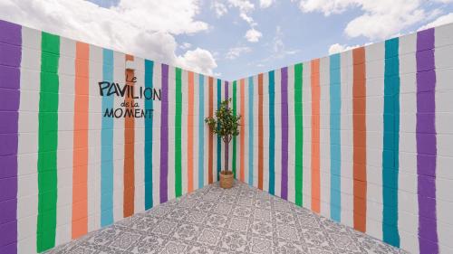 a room with a colorful wall with a potted plant at Le Pavilion Pool Villa in Pohang