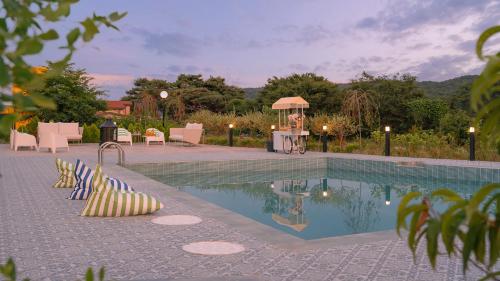 a swimming pool with chairs and a gazebo at Le Pavilion Pool Villa in Pohang