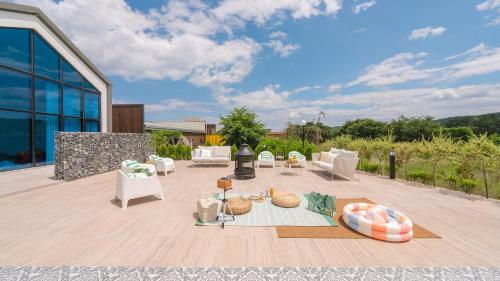 a patio with couches and chairs on a wooden deck at Le Pavilion Pool Villa in Pohang