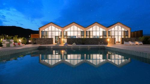 a house with a swimming pool at night at Le Pavilion Pool Villa in Pohang