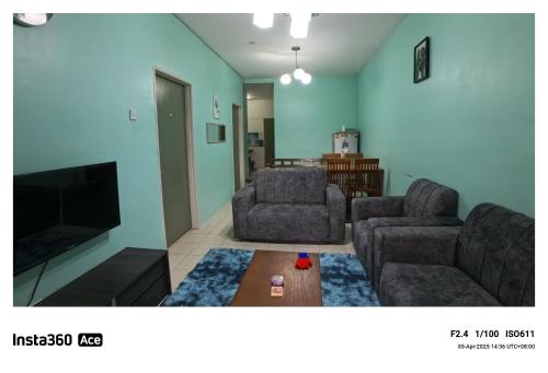 a living room with two chairs and a television at Fizan Homestay in Tanah Rata