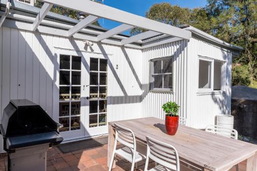 a patio with a wooden table and a grill at Romantic Getaway - Private Guest Suite - Country setting amongst Orange's best Wineries in Orange