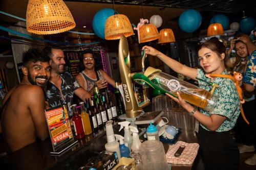 a woman pouring a drink at a bar at Mad Monkey Phuket in Patong Beach