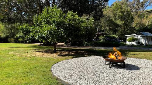 a fire pit sitting on top of a pile of gravel at Romantic Getaway - Private Guest Suite - Country setting amongst Orange's best Wineries in Orange