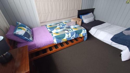 a room with two beds and a bedskirts at Home with sea views in New Plymouth