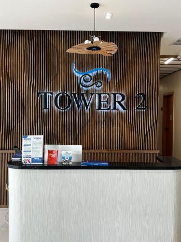 a showroom counter with a sign on a wall at Antara Residences in Talisay