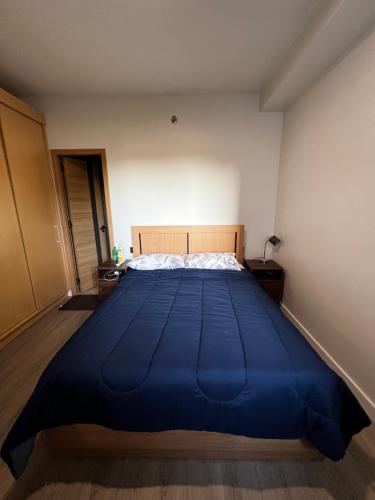 a large blue bed in a small bedroom at Antara Residences in Talisay