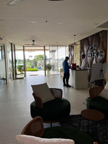 a lobby with a person standing at a counter in a lobby at Antara Residences in Talisay