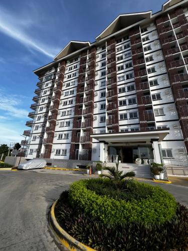 a large apartment building in front of a parking lot at Antara Residences in Talisay