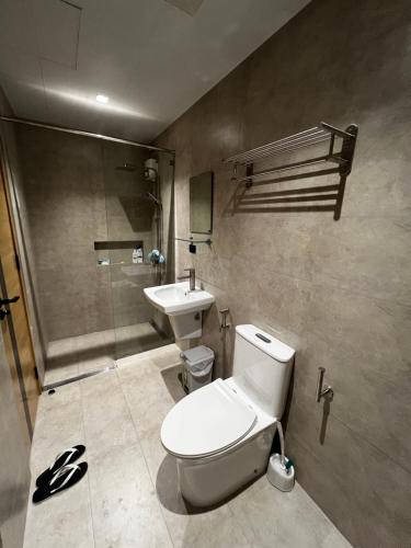 a bathroom with a toilet and a sink at Antara Residences in Talisay