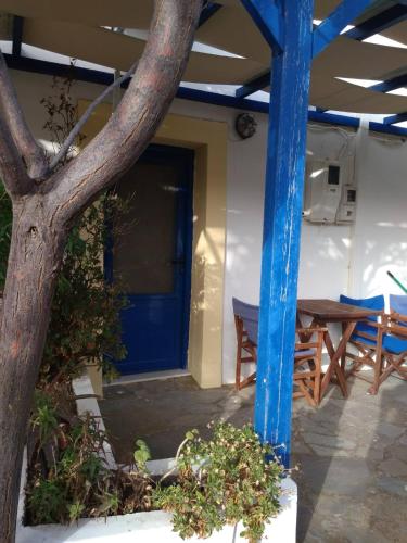 a blue door of a house with a table at Kouvaras Apartments in Kýthira