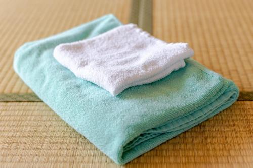 a stack of towels sitting on top of a table at Magic hour nasu Tochigi BBQ available in Nasu-yumoto