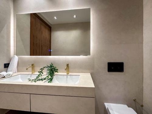 a bathroom with a large sink and a mirror at Marina Garden Cap Cana by Beach Homes Punta Cana in Punta Cana