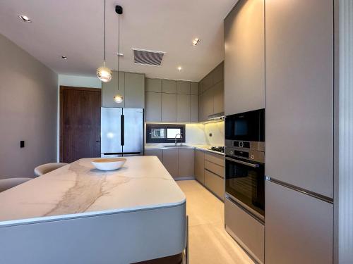 a kitchen with a white counter top in a room at Marina Garden Cap Cana by Beach Homes Punta Cana in Punta Cana