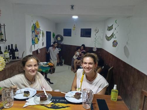 two girls sitting at a table eating chocolate cake at The Kingston Court in Kandy