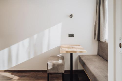 a room with a staircase and a chair at Feichter Hotel & Bistro in Bolzano