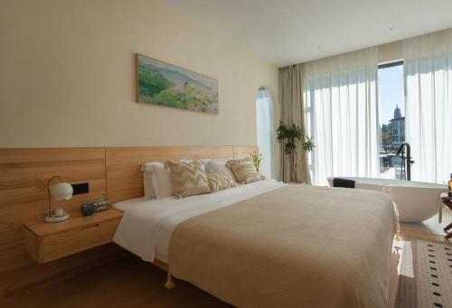 a bedroom with a large bed and a large window at The White Courtyard in Dali