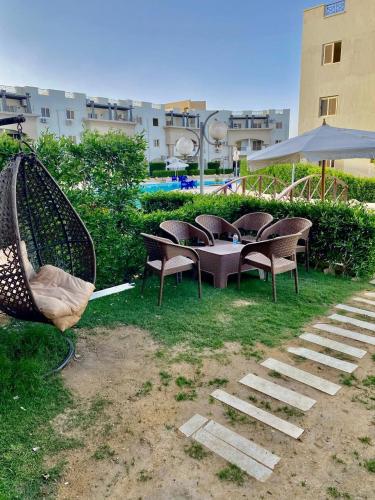 a group of chairs and a table in the grass at شاليه 3 غرف Lasrina mini Egypt in Ain Sokhna