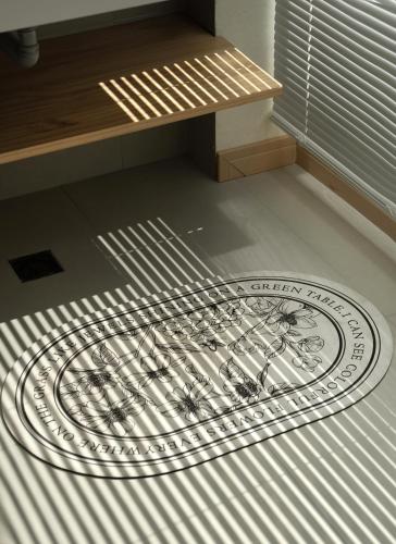 a rug on the floor in a room with a bench at The White Courtyard in Dali