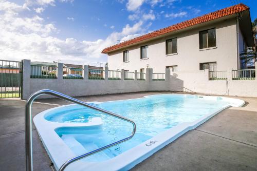 a swimming pool in front of a building at Charming 2-Bed Apartment with Bay Views in Batemans Bay