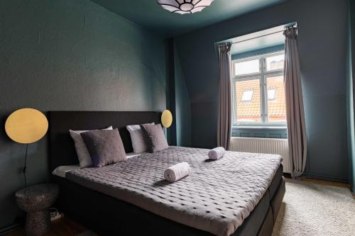a bedroom with a bed with two towels on it at Rustic & Cozy 2BR in Heart of CPH City by Strøget in Copenhagen