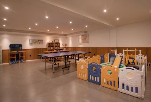 a room with a table and play equipment in it at The White Courtyard in Dali