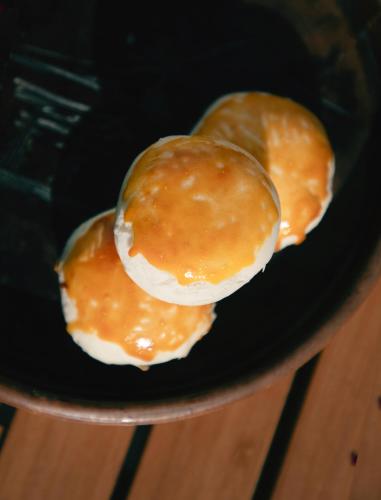 two donuts sitting on top of a black plate at The White Courtyard in Dali