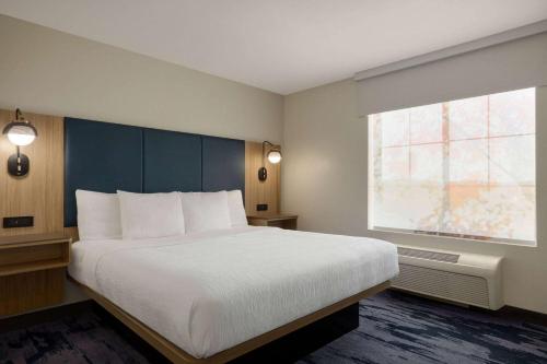 a bedroom with a large bed and a window at La Quinta by Wyndham Austin Southwest in Austin