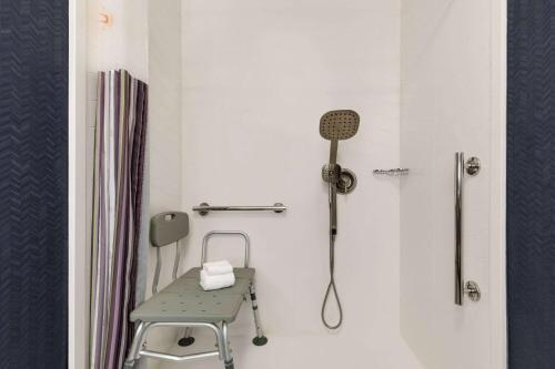 a hospital room with a chair and a shower at La Quinta by Wyndham Austin Southwest in Austin