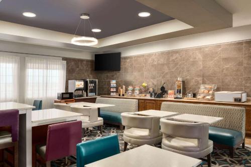 a restaurant with tables and chairs and a counter at La Quinta by Wyndham Dumas in Dumas