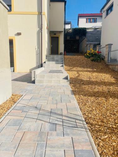 a stone walkway in front of a house at Jenys Apartment Usti in Ústí nad Labem