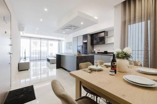 a dining room and kitchen with a table and chairs at Clover Leaf Apartment B 03 by Homely Malta! in St. Paul's Bay