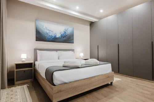 a bedroom with a bed and a painting on the wall at Clover Leaf Apartment B 03 by Homely Malta! in St. Paul's Bay