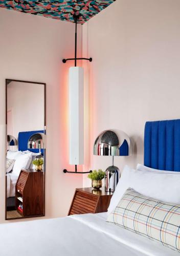 a bedroom with a large bed with a mirror at Graduate by Hilton New York in New York
