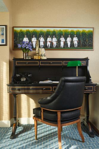 a black piano with a chair in front of it at Graduate by Hilton Iowa City in Iowa City