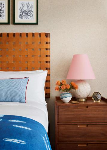 a bedroom with a bed and a lamp on a dresser at Graduate by Hilton Tucson in Tucson