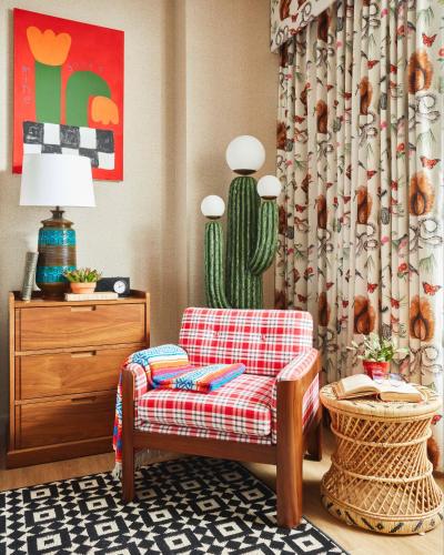 a living room with a chair and a cactus at Graduate by Hilton Tucson in Tucson