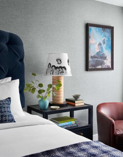 a bedroom with a bed and a table with a lamp at Graduate by Hilton Storrs in Storrs