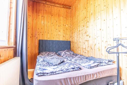 a bedroom with a bed in a wooden wall at Cozy Central 11BR shared Stay with Garden Access & Terrace in Vienna