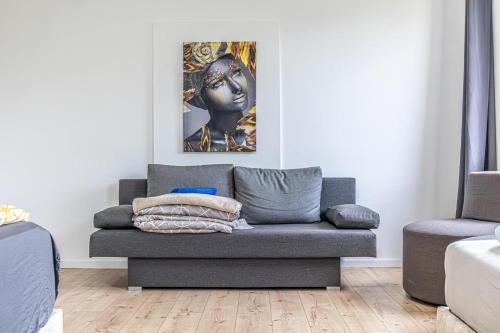 a living room with a couch and a statue at Cozy Central 11BR shared Stay with Garden Access & Terrace in Vienna