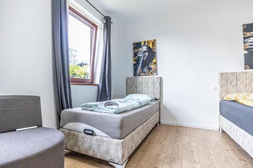 a room with two beds and a window at Cozy Central 11BR shared Stay with Garden Access & Terrace in Vienna