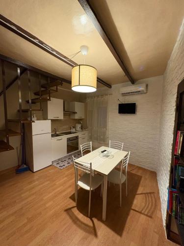 a kitchen and dining room with a table and chairs at LA CASA DEL BORGO in Campoli Appennino