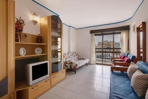 a living room with a flat screen tv and a couch at A sua casa no Algarve in Armação de Pêra