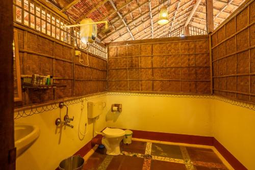 a bathroom with a toilet and a sink at Bhakti Kutir in Palolem