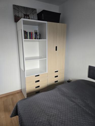 a bedroom with a white cabinet and a bed at Haus Dresden, Pool, Garten, Terrasse, familienfreundlich in Dresden