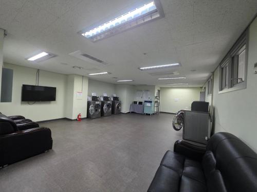 a large room with a waiting room with washing machines at W Residence Hotel Centum City in Busan