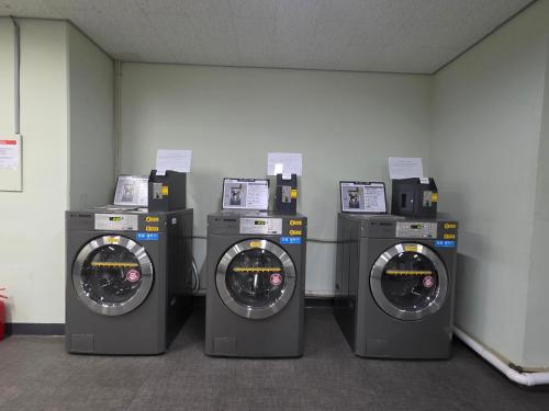 a group of four washing machines in a room at W Residence Hotel Centum City in Busan