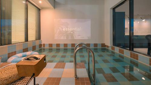a room with a swimming pool with a desk in it at Le Pavilion Pool Villa in Pohang